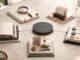 Five modular work tools connected to a central hub on a warm stone table, representing a practical AI operating system.