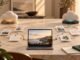 Two parallel cloud-based work paths connect task cards to one finished digital asset on a warm stone desk.